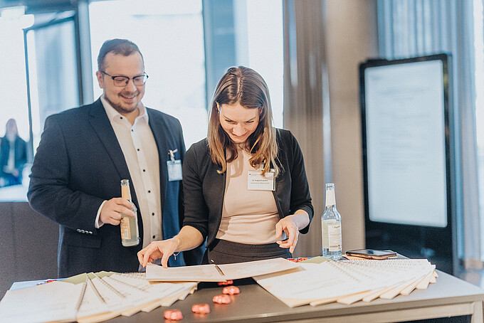 Two participants are looking at documents
